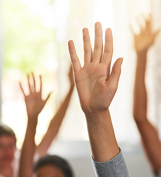 Hands raising in a classroom